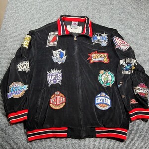 May include: A black velour zip-up jacket featuring various embroidered NBA team logos and conference patches. The jacket has a collared neckline with red and white striped trim on the collar, cuffs, and hem, and a full-length front zipper closure.