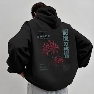 May include: A black hooded sweatshirt featuring a graphic on the back with two red spider lily flowers. The design includes Japanese text, the English words "FADE SIGNAL" and "MEMORY TRACE," and small geometric symbols in a light blue color.