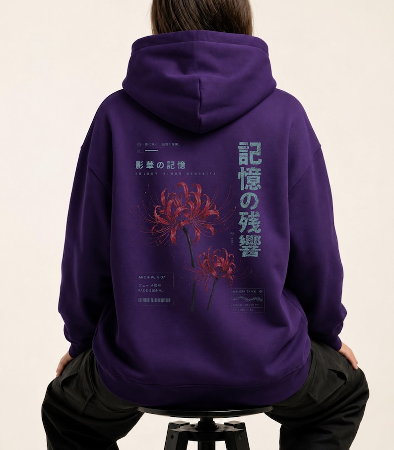 May include: A deep purple hooded sweatshirt featuring a graphic on the back with two red spider lily flowers. The design includes Japanese text, the English phrase "Archive / 07", and technical-style markings in a light blue and white color palette.
