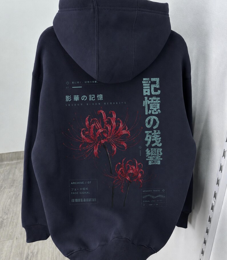 May include: A dark charcoal gray hooded sweatshirt featuring a back graphic of two red spider lilies. The design includes Japanese text, the phrase "Archive 07," "Fade Signal," and "Memory Trace" printed in white and light blue lettering.
