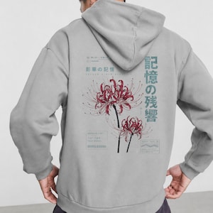 May include: A light gray hooded sweatshirt featuring a back graphic of two red spider lilies. The design includes Japanese text, technical-style boxes, and the English words "ARCHIVE LIST" and "MEMORY TRAIL" printed in a dark blue-gray ink.