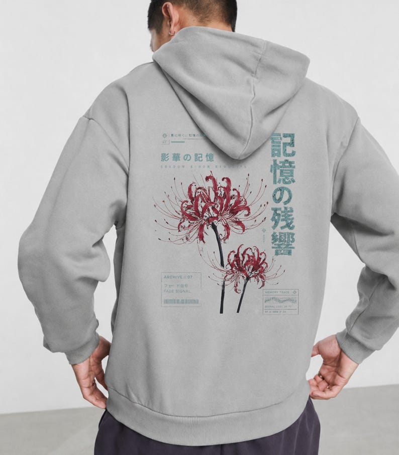 May include: A light gray hooded sweatshirt featuring a back graphic of two red spider lilies. The design includes Japanese text, technical-style boxes, and the English words "ARCHIVE LIST" and "MEMORY TRAIL" printed in a dark blue-gray ink.
