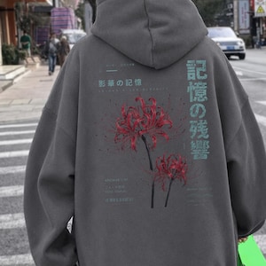 May include: A charcoal gray hooded sweatshirt featuring a back graphic of two red spider lily flowers. The design includes light blue Japanese text characters and smaller English text elements, including the words Archive 007 and Fade Signal.