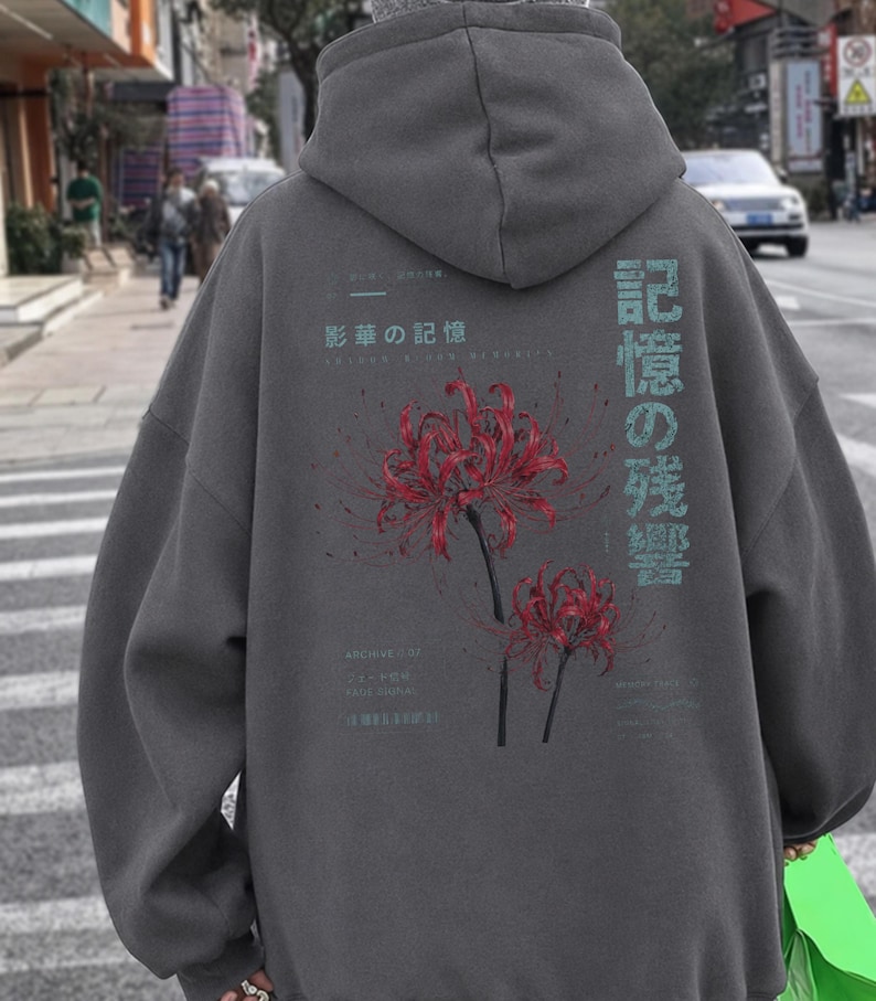 May include: A charcoal gray hooded sweatshirt featuring a back graphic of two red spider lily flowers. The design includes light blue Japanese text characters and smaller English text elements, including the words Archive 007 and Fade Signal.