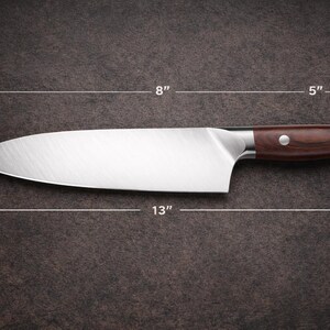 May include: A stainless steel chef's knife with a dark brown wooden handle. The blade is 13 inches long, 2 inches wide, and the handle is 5 inches long. The knife is 8 inches from the blade's tip to the handle's base, and the handle is 1 inch thick.
