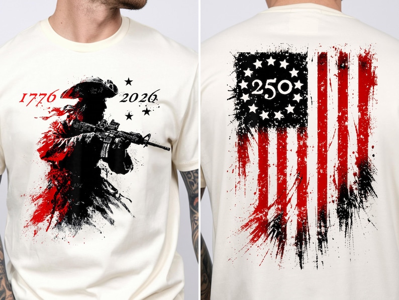 以下が含まれることがあります： クリーム色のTシャツ。独立戦争の兵士がライフルを持っているグラフィックが黒と赤で描かれています。シャツの前面には「1776」と「2026」の数字が、背面には「250」の数字が入った、使い古されたアメリカ国旗のデザインが施されています。