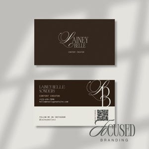 May include: Two business cards with a brown and white design. The top card features the name "Lainey Belle" and the words "Content Creator." The bottom card includes contact information, Instagram handle, and a QR code. The words "Focused Branding" are at the bottom.