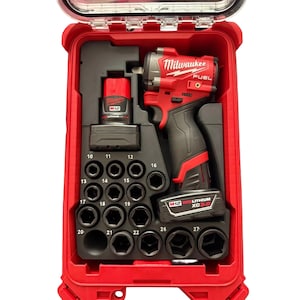 May include: A red Milwaukee M12 FUEL impact wrench with a black battery pack, stored in a red plastic carrying case. The case includes a moulded insert holding a set of black metal sockets labelled with numerical sizes ranging from 10 to 27.