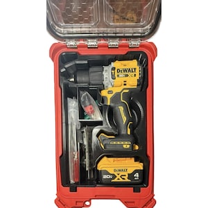May include: A yellow and black DeWalt 20V XR brushless drill with a battery pack, stored inside a red hard-shell carrying case with a clear lid. The set includes a small screwdriver and various small hardware components in plastic bags.