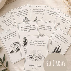 May include: A set of thirty off-white rectangular cards featuring black ink illustrations and inspirational text. Each card displays a unique theme such as Pray, Persist, Breathe, Focus, Believe, Courage, Strength, Joy, Hope, and Rest.
