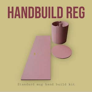 May include: A pink hand-build mug kit with the text "HANDBUILD REG" at the top. The kit includes a cylindrical mug body, a circular base, and a rectangular piece. The text "Standard mug hand build kit" is at the bottom.
