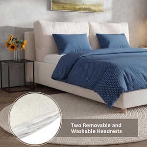 May include: A bed with a cream-colored headboard and a navy blue duvet cover and pillow set with white polka dots. A small black side table holds a vase of sunflowers. The text reads: "Two Removable and Washable Headrests."