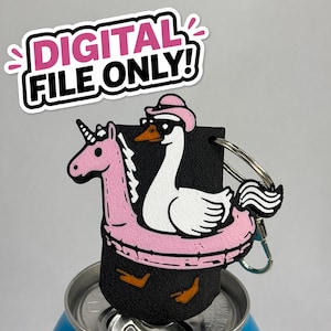 May include: A novelty keyring featuring a pink unicorn riding a pink inflatable ring, with a white swan wearing a pink hat and sunglasses. The keyring has a black background and the text "DIGITAL FILE ONLY!"