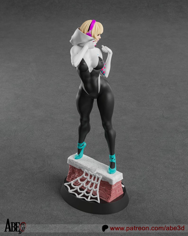 May include: A figurine of a female superhero in a black and white bodysuit, with a hood and pink headphones. She stands on a brick structure with a white spiderweb design, wearing teal shoes. The base is black. The figurine is a collectible.