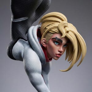 May include: A detailed figurine of a female character with blonde hair styled in a high ponytail. She wears a white and light blue hooded jacket with red accents. The figure has blue eyes and a piercing.