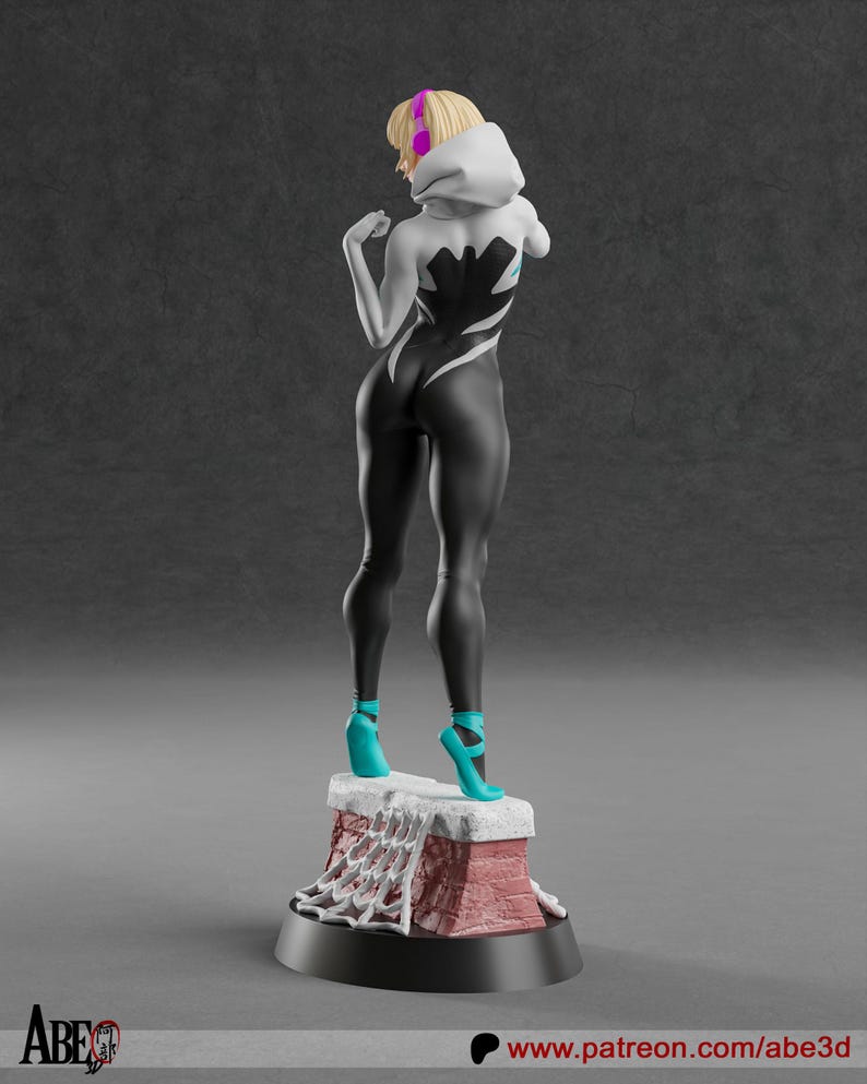 May include: A figurine of a female superhero in a black and white suit with a spiderweb design. She wears a white hooded jacket, teal high heels, and has blonde hair. The figurine stands on a red and white base.