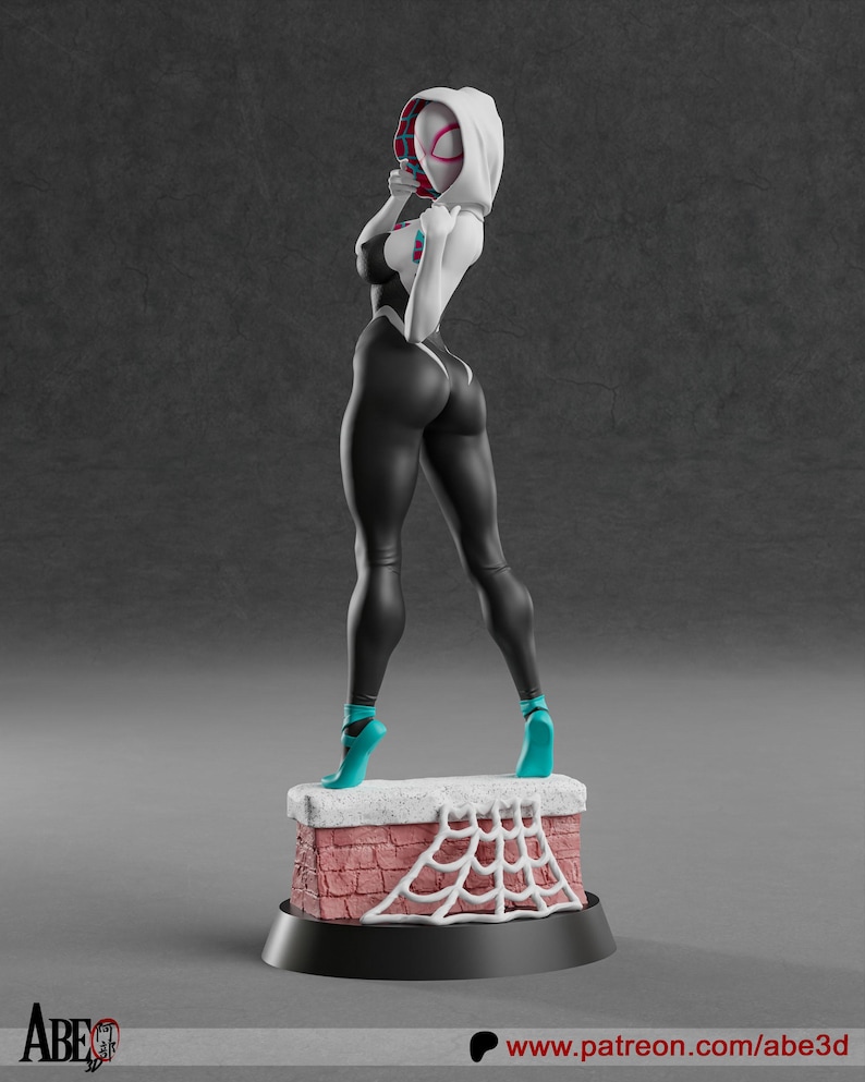 May include: A 3D-printed figurine of a female superhero in a black and white costume, teal heels, and a white hood. The figure stands on a brick-like base with a white spiderweb design. The base is on a black circular stand.
