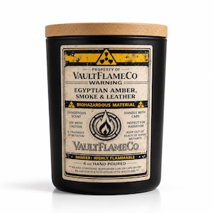 May include: A black 6 oz hand-poured candle with a wooden lid. The label reads "Egyptian Amber, Smoke & Leather" and includes warnings about flammability and biohazardous material. The candle is from VaultFlameCo.