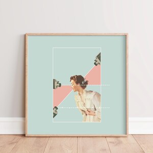 May include: A framed collage art print featuring a person in a white shirt centered within a light blue rectangle. Three vintage cameras are positioned on the left and top, with a pink diagonal shape and white dashed lines connecting them to the person.