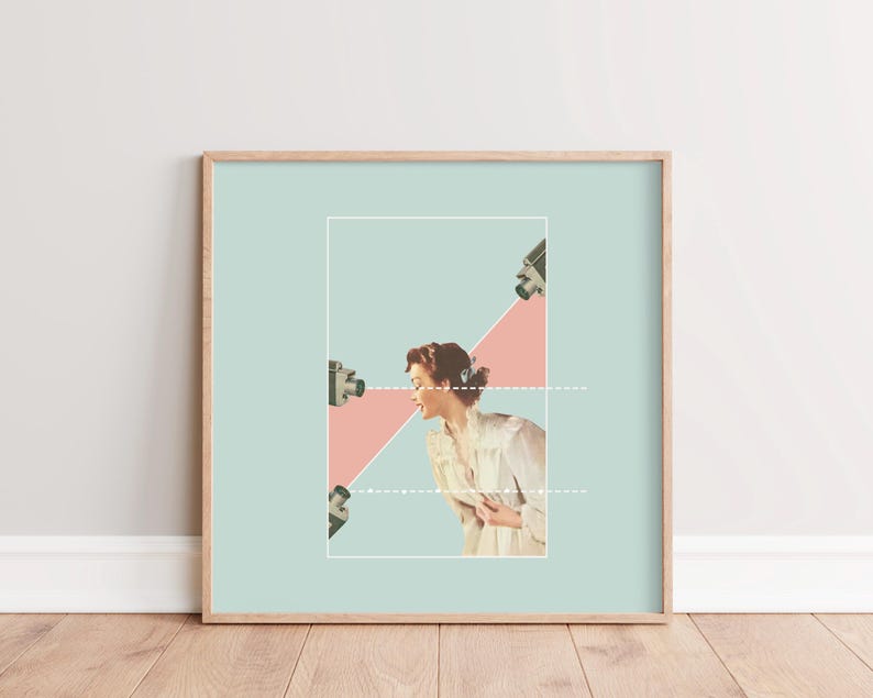 May include: A framed collage art print featuring a person in a white shirt centered within a light blue rectangle. Three vintage cameras are positioned on the left and top, with a pink diagonal shape and white dashed lines connecting them to the person.