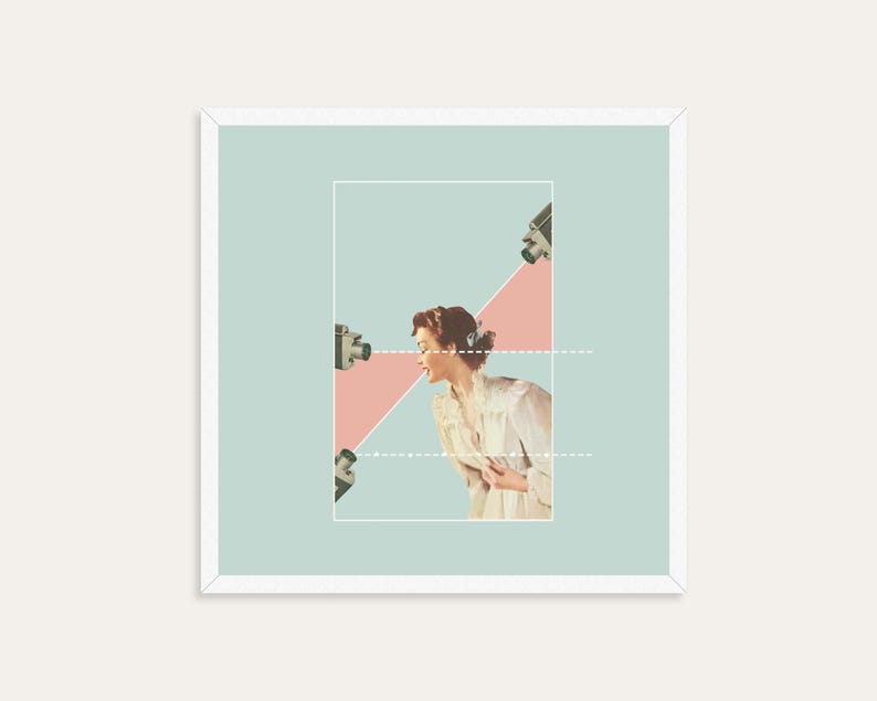 May include: A square framed art print featuring a collage of a person in a light-colored blouse positioned within a rectangular border. Three vintage cameras are directed toward the person, with pink triangular shapes and white dotted lines.