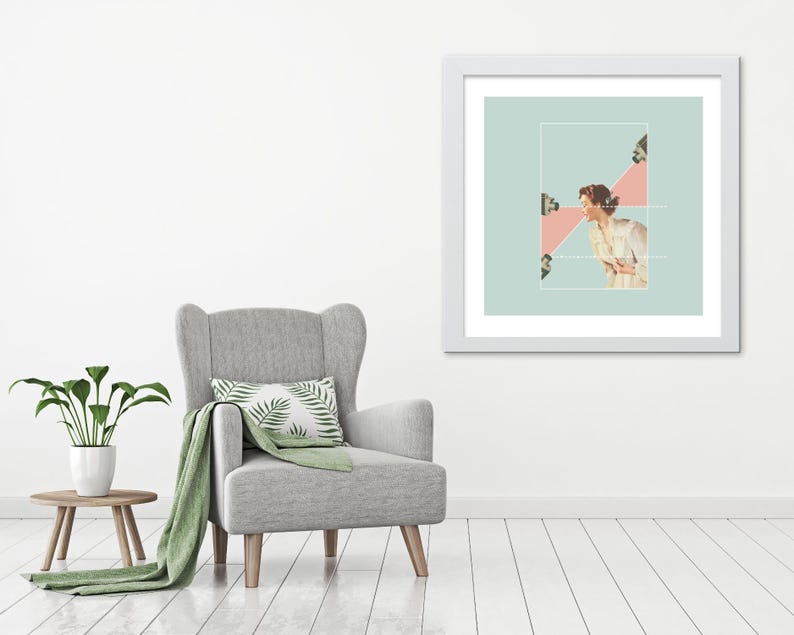 May include: A framed wall art print featuring a collage of a person in a light-colored shirt facing three cameras. The artwork is set against a pale green background with a pink triangular shape highlighting the interaction between the subject and cameras.