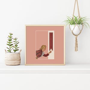 May include: A square framed print featuring a vintage-style illustration of a blonde person in a maroon jacket reaching toward a vertical maroon banner with the word SMILE printed in white. The artwork is set against a muted dusty rose background.
