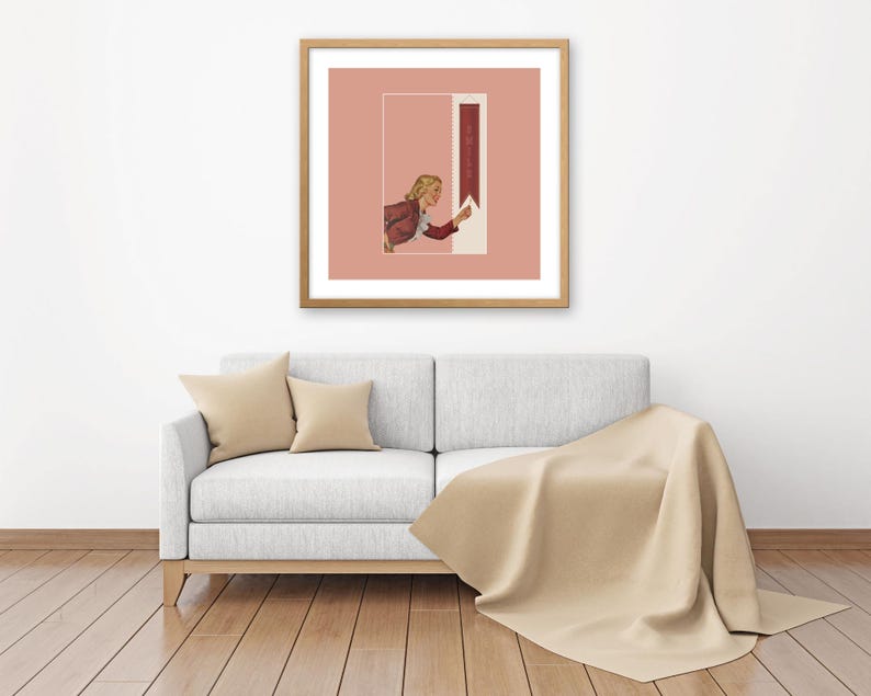 May include: A square framed wall art piece featuring a muted pink background with a central rectangular graphic. The graphic depicts a person in a maroon jacket reaching toward a vertical maroon banner containing the white text "SHINE".