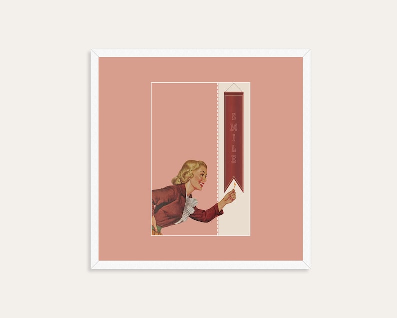 May include: A square framed print featuring a vintage-style illustration of a blonde person in a red jacket with a white ruffled collar. The person reaches toward a vertical red banner with the word SMILE printed in white capital letters.