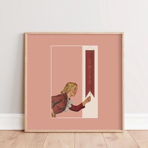 May include: A square framed wall art print featuring a dusty rose background. The illustration depicts a blonde person in a maroon jacket with a white ruffled collar, reaching toward a vertical maroon banner that displays the word SMILE in white.