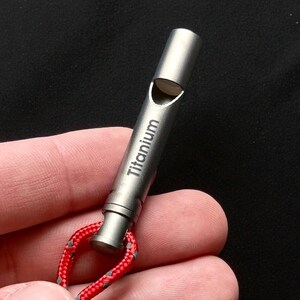 Silbato de emergencia ultraligero de titanio de alto decibelio para actividades al aire libre, senderismo, camping y uso diario. Llavero resistente a la corrosión.