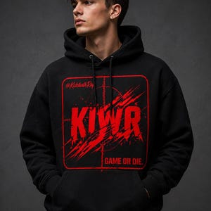 May include: Black hoodie with a red graphic that says "KIWR" inside a red square with a crosshair design. The text "GAME OR DIE" is below the graphic. The hoodie has a drawstring hood and a front pocket.