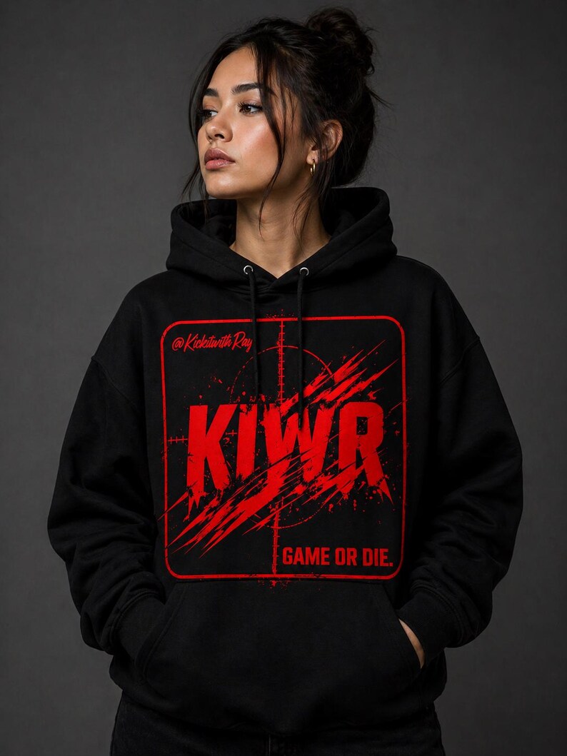 May include: Black hoodie with a red graphic design. The design includes the letters "KIWR" in a bold, distressed font, a target, and the phrase "GAME OR DIE." The text "@KickinwithRay" is also present. The hoodie has a drawstring hood and a front pocket.