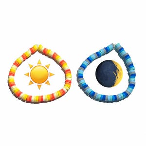 May include: Two circular bracelets made of flat, disc-shaped polymer clay beads. The left bracelet features a warm color palette of yellow, orange, and white, accompanied by a sun icon. The right bracelet uses cool blue, grey, and white tones with a moon icon.