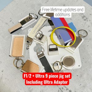 May include: A collection of keychains and a white plastic jig set with a yellow rubber band. The image includes text that reads Free lifetime updates and additions and F1/2 + Ultra 9 piece jig set Including Ultra Adapter on a gray surface.
