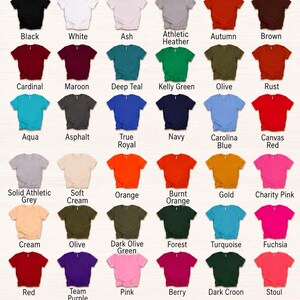 May include: A Bella+Canvas 3001 unisex t-shirt color and size chart displaying thirty-six folded t-shirts in various solid colors with corresponding labels. A table at the bottom lists available sizes from XS to 5XL with width and length in inches.