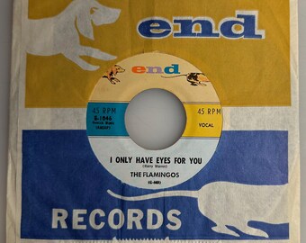 May include: Vintage 45 RPM record sleeve featuring a yellow and blue design with the word "end" in blue. The record label reads "I Only Have Eyes For You" by The Flamingos. The sleeve has a dog silhouette.