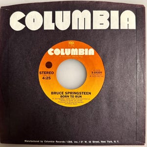 Peut inclure: Pochette de disque vinyle 45 tours Columbia Records vintage. La pochette est noire avec le mot "COLUMBIA" en grandes lettres blanches en haut. L'étiquette du disque est orange et jaune, avec le texte "BRUCE SPRINGSTEEN BORN TO RUN".