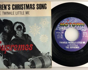 May include: A vintage vinyl record by The Supremes, titled "Children's Christmas Song: Twinkle Twinkle Little Me". The record is black with a colorful label featuring the Motown Records logo.