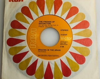 May include: A vintage 7" vinyl record by The Friends of Distinction. The record is titled "Grazing in the Grass" and is a stereo recording. The label is red, white, and gold with the RCA Victor logo.
