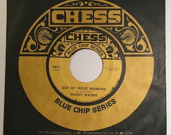 May include: A gold vinyl record with a black label. The label features the text "CHESS BLUE CHIP SERIES" and "GOT MY MOJO WORKING (M. Morganfield) MUDDY WATERS". The record number is 9011 (10544).