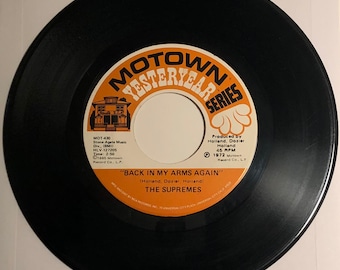May include: A black vinyl record with a white label. The label has a red and yellow Motown logo and the text "Motown Yesterday Series". The record is titled "Back in My Arms Again" by The Supremes.