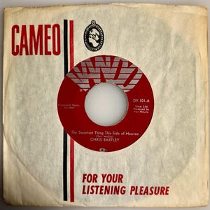 May include: Vintage 45 RPM record by Chris Bartley, titled "The Sweetest Thing This Side of Heaven." The record label is red with white text and a white center. The record sleeve is off-white with the word "CAMEO" in red.