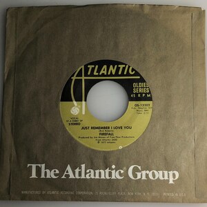 May include: A brown vinyl record with a black and gold label. The label says "Atlantic Oldies Series 45 RPM" and features the song "Just Remember I Love You" by Firefall. The record is manufactured by Atlantic Recording Corporation.