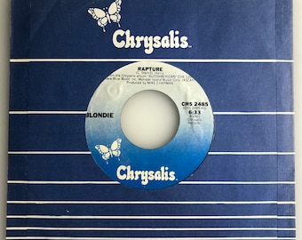 May include: A blue vinyl record with a white label. The label has a butterfly logo and the text "Chrysalis" in white. The record is titled "Rapture" by Blondie. The record is from 1981 and is on the Chrysalis label.