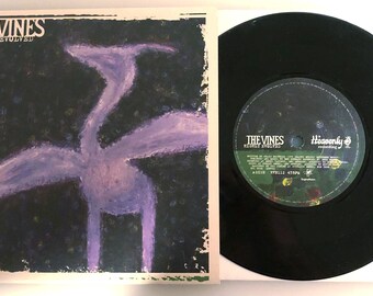 May include: A black vinyl record with a purple and white illustration of a bird on the album cover. The album cover has the text "THE VINES HIGHLY EVOLVED" on it.