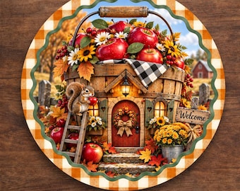 May include: A round aluminum sign featuring a basket shaped like a house with a red door, a squirrel, and red apples. The border has an orange and white gingham pattern. The sign includes the text Welcome and Available in 4 Sizes.