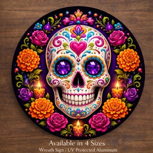 May include: A circular sign featuring a white sugar skull with intricate colorful patterns, purple gemstone eyes, and a heart on the forehead. The skull is surrounded by orange marigolds, pink roses, and three lit candles. Text reads: Available in 4 Sizes.