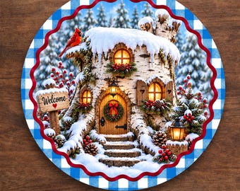 May include: A round aluminum wreath sign featuring a winter scene of a birch tree stump house covered in snow. The house has glowing windows, a wooden door with a wreath, and a sign that reads Welcome with a red heart. A red cardinal sits on top.