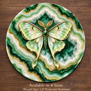 May include: A circular wall plaque featuring a central moth with translucent light green wings and a dark green body, set against a background of layered green and white agate-like patterns with gold accents. Text reads: Available in 4 Sizes.